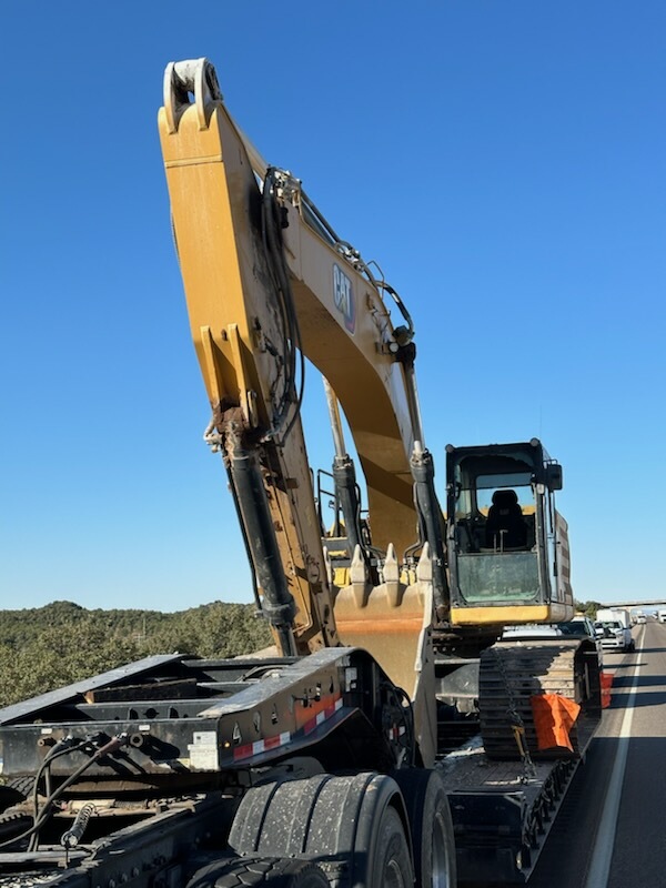 Image of the damaged excavator after hitting the bridge.