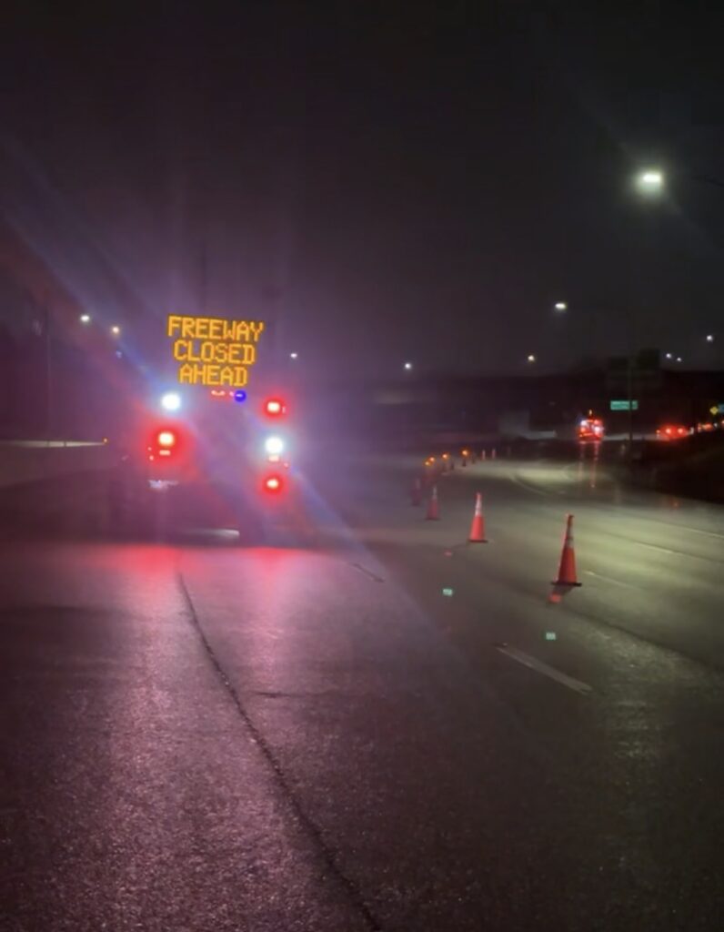IMT truck with freeway closed ahead sign with traffic cones