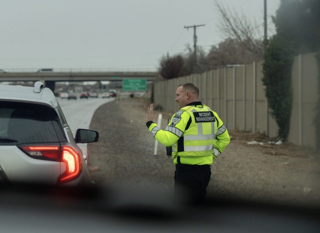 IMT assisting a motorist on the side of the freeway